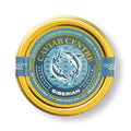 Close-up of luxurious Siberian caviar served on mother-of-pearl spoon with blinis and crème fraîche